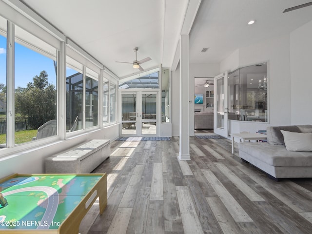 unfurnished sunroom with ceiling fan