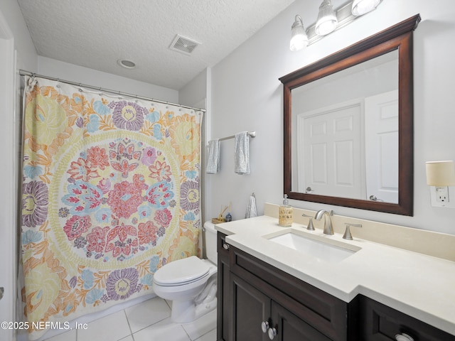 bathroom with tile patterned floors, visible vents, toilet, a textured ceiling, and vanity