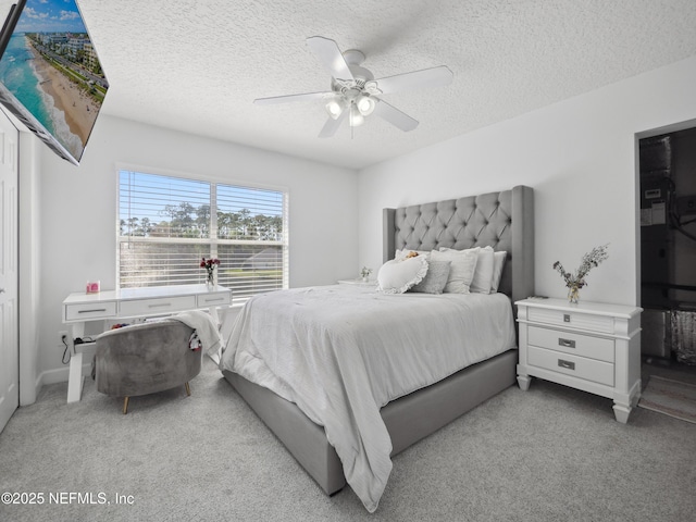 bedroom with light carpet, a textured ceiling, and a ceiling fan