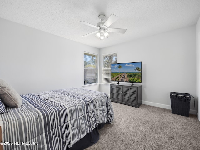 carpeted bedroom with ceiling fan, baseboards, and a textured ceiling