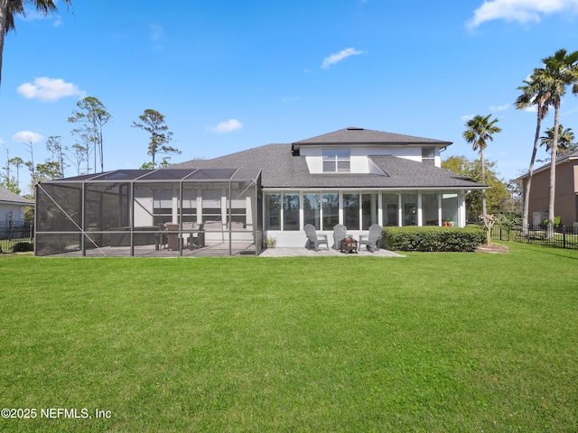 rear view of property with a lawn, a patio, fence, glass enclosure, and roof with shingles