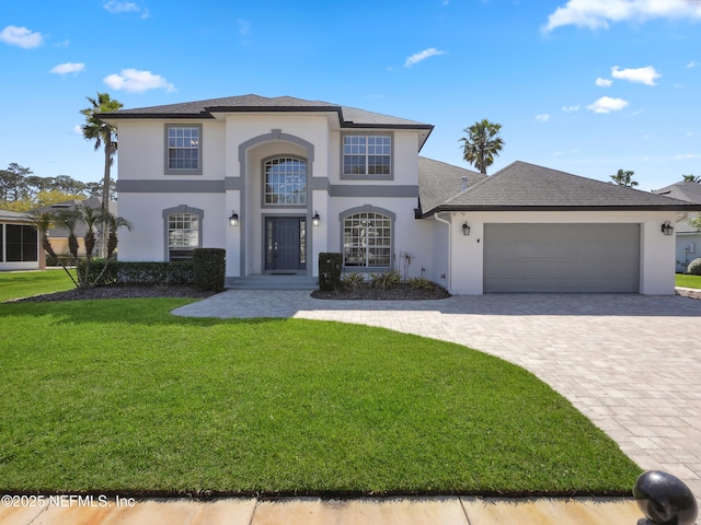 view of front of house featuring stucco siding, a front lawn, decorative driveway, roof with shingles, and an attached garage