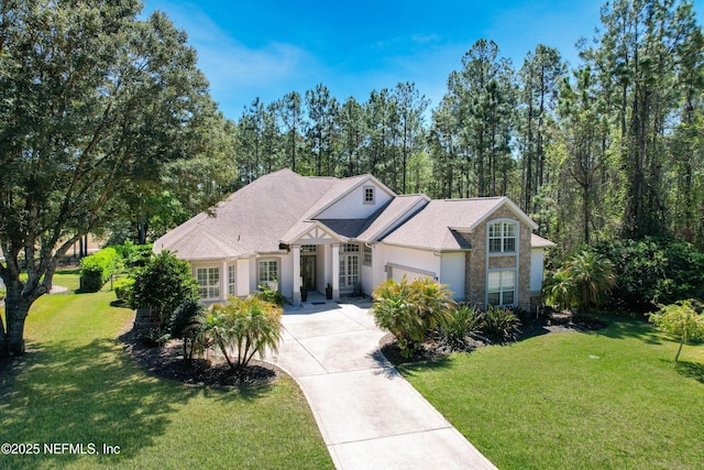 297 S Hampton Club Way, Saint Augustine, FL 32092 - view of front of house with stucco siding, a front yard, driveway, and a garage