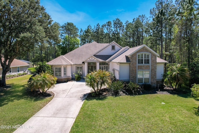 297 S Hampton Club Way, Saint Augustine, FL 32092 - view of front of property featuring a front lawn, driveway, stone siding, and a garage