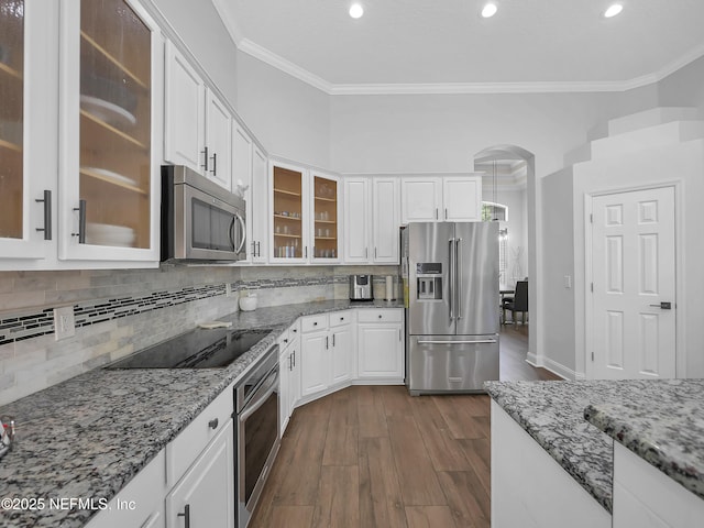 297 S Hampton Club Way, Saint Augustine, FL 32092 - kitchen with ornamental molding, decorative backsplash, dark wood finished floors, white cabinets, and appliances with stainless steel finishes