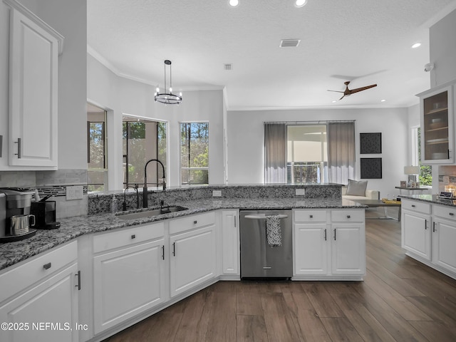 297 S Hampton Club Way, Saint Augustine, FL 32092 - kitchen featuring dark wood-style flooring, ornamental molding, stainless steel dishwasher, a sink, and white cabinets