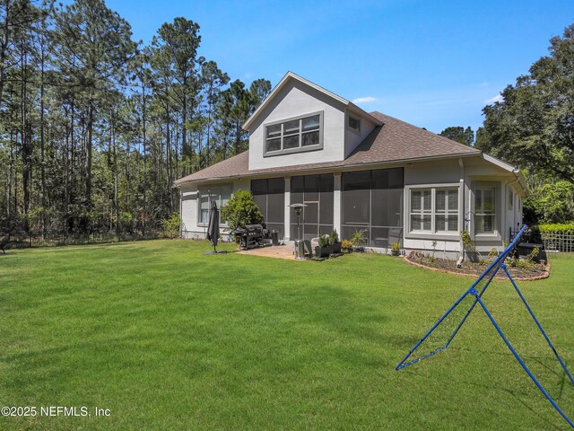 297 S Hampton Club Way, Saint Augustine, FL 32092 - rear view of house with a yard, a sunroom, and roof with shingles