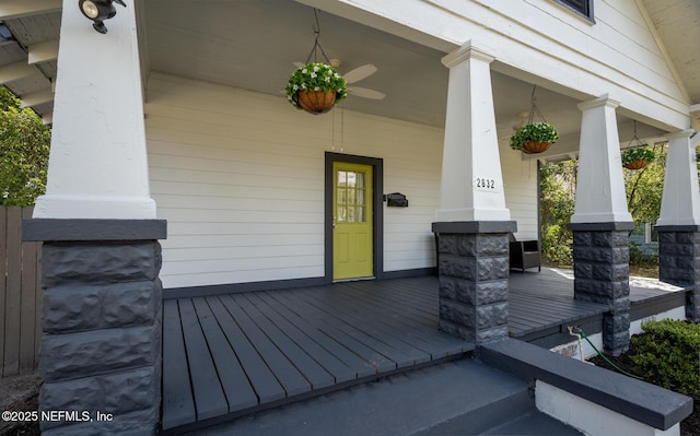 deck with covered porch and ceiling fan