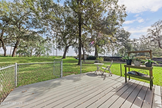 wooden deck with a yard and fence