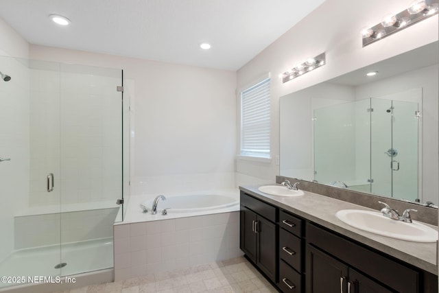 full bathroom featuring a sink, a bath, and a shower stall