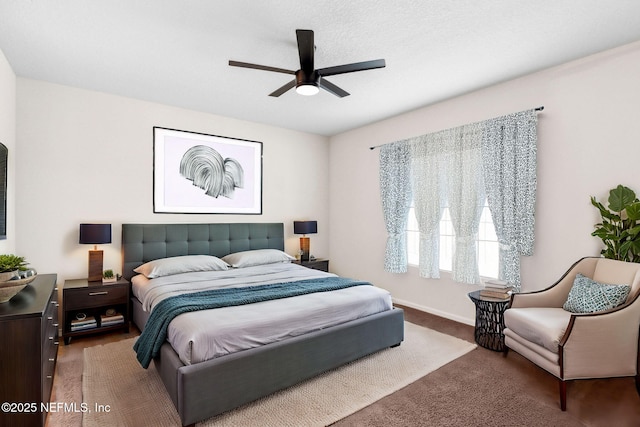 bedroom featuring a ceiling fan, carpet, and baseboards