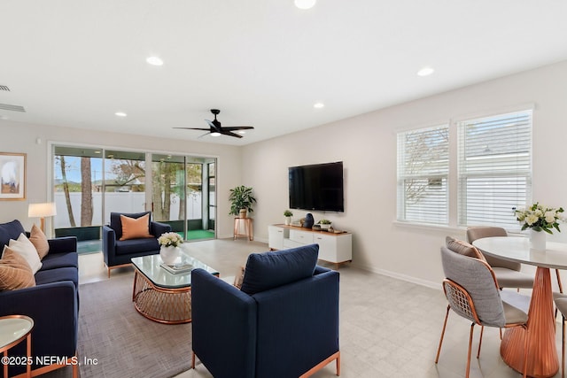 living room with light floors, baseboards, a ceiling fan, and recessed lighting