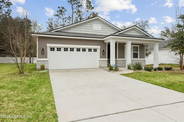 view of front facade featuring concrete driveway, covered porch, an attached garage, a front yard, and stone siding