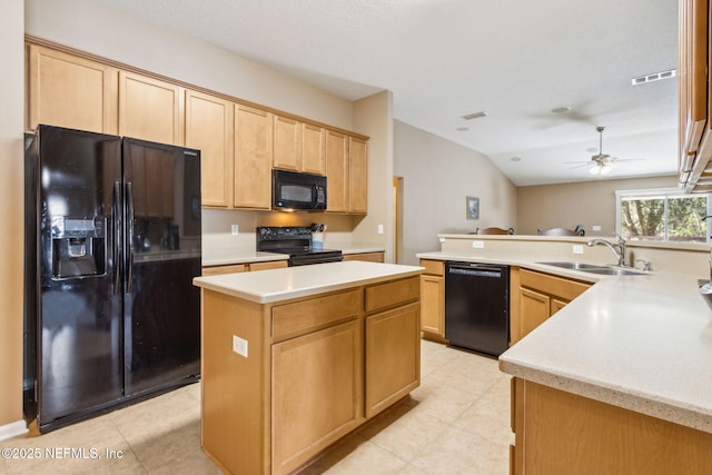 kitchen featuring black appliances, a kitchen island, light countertops, and a sink