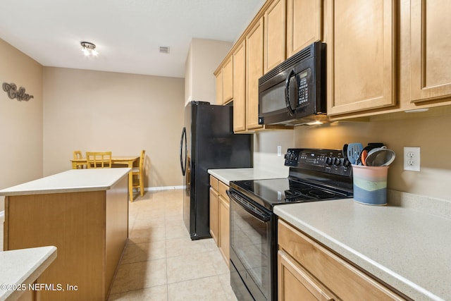 kitchen featuring a center island, light tile patterned floors, light countertops, visible vents, and black appliances