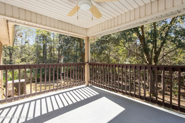 unfurnished sunroom with plenty of natural light and a ceiling fan