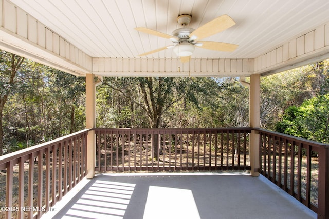 wooden terrace featuring a porch and a ceiling fan