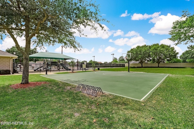 view of property's community featuring community basketball court, fence, playground community, and a yard