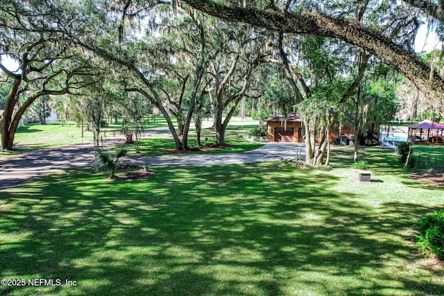 view of home's community featuring an outbuilding and a lawn