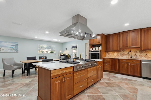 17524 Eagle Bend Blvd, Jacksonville, FL 32226 - kitchen featuring tasteful backsplash, brown cabinetry, appliances with stainless steel finishes, island exhaust hood, and a sink