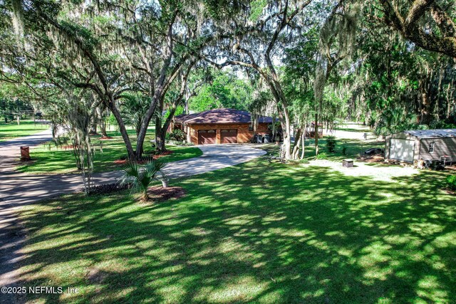 17524 Eagle Bend Blvd, Jacksonville, FL 32226 - view of yard with an outbuilding and a storage unit