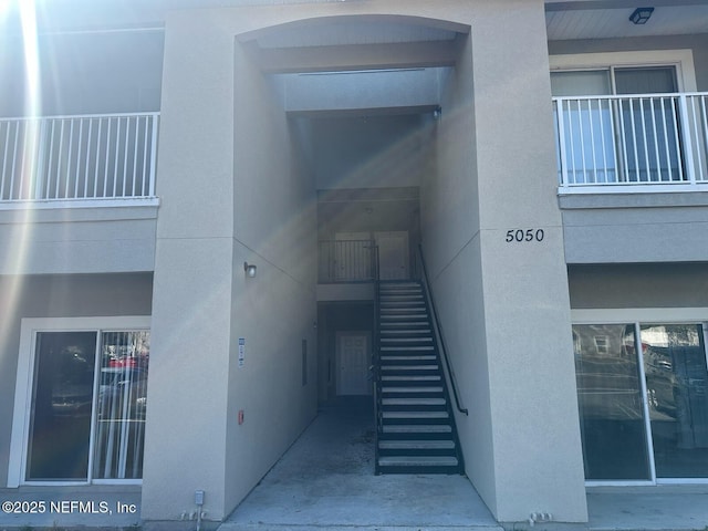 entrance to property with stucco siding