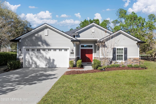 view of front of property featuring an attached garage, stone siding, concrete driveway, and a front yard