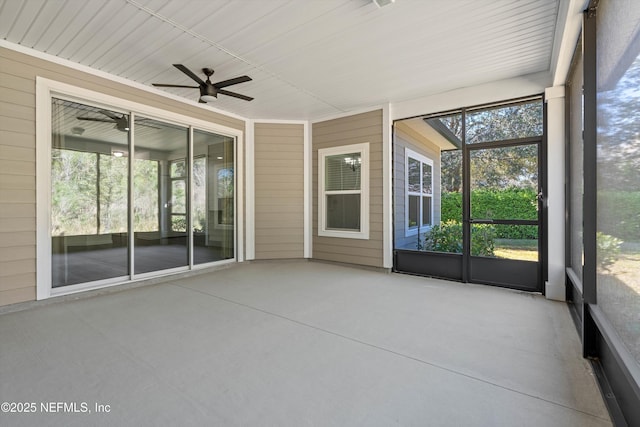 unfurnished sunroom with a ceiling fan