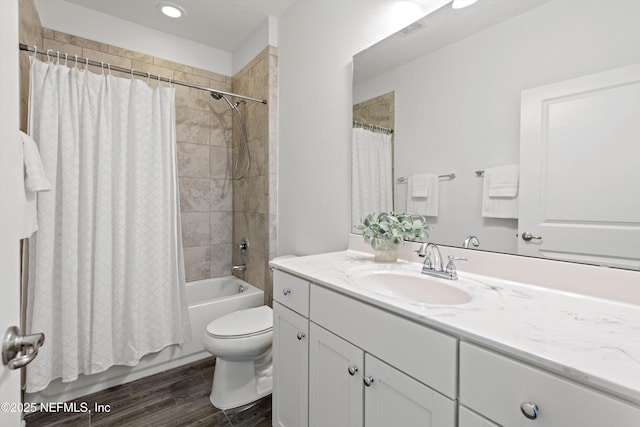 bathroom with visible vents, toilet, wood finished floors, shower / bath combination with curtain, and vanity