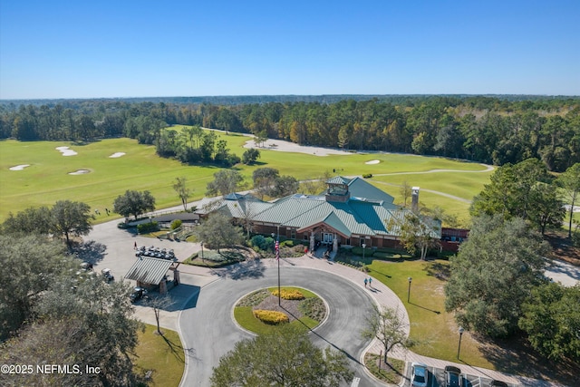 drone / aerial view featuring a wooded view and golf course view