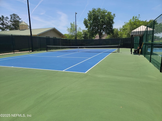 view of tennis court with fence