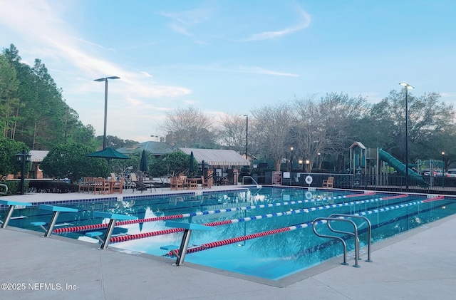 pool featuring fence and a patio