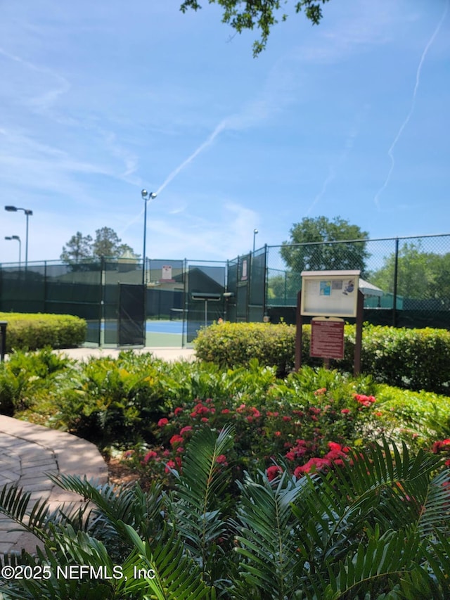 view of sport court featuring fence