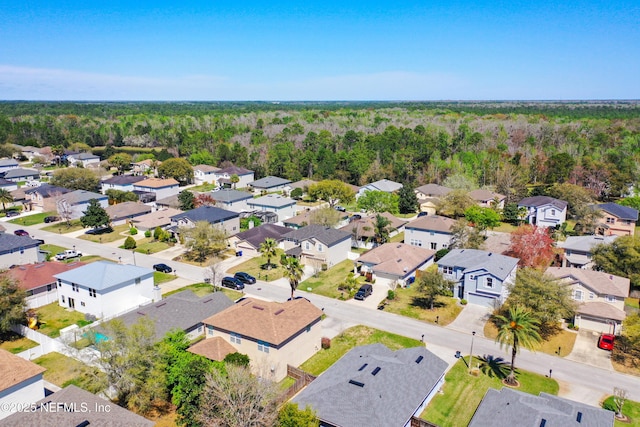 aerial view featuring a residential view and a wooded view