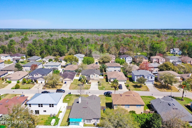 birds eye view of property featuring a residential view and a view of trees