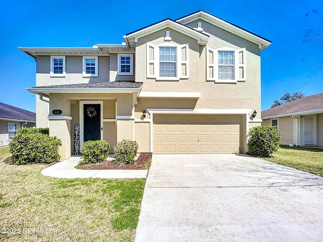 view of front facade featuring a front lawn, a garage, driveway, and stucco siding