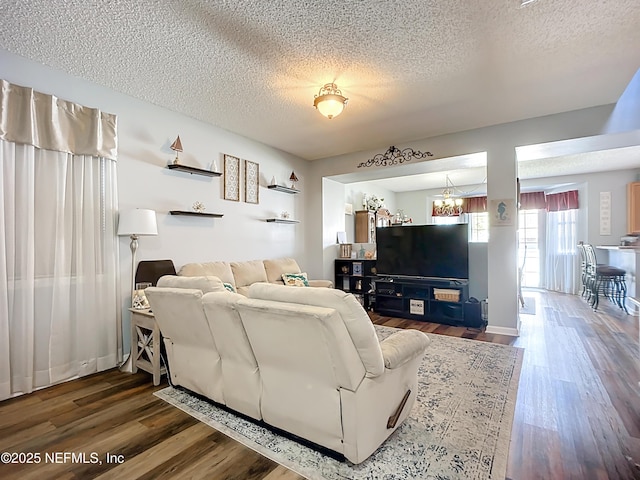 living area featuring a textured ceiling and wood finished floors