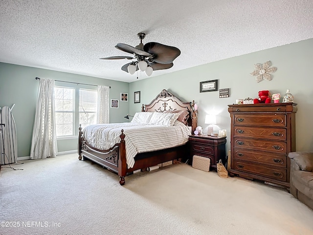 bedroom featuring carpet flooring, a textured ceiling, and a ceiling fan