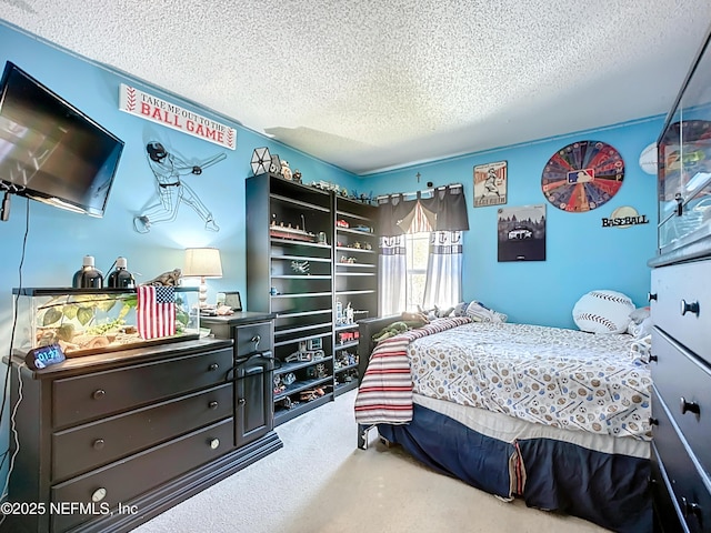 bedroom with carpet floors and a textured ceiling