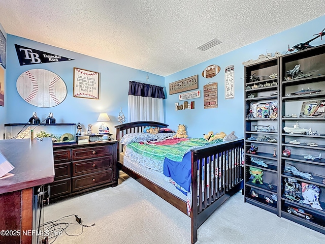 carpeted bedroom with visible vents and a textured ceiling