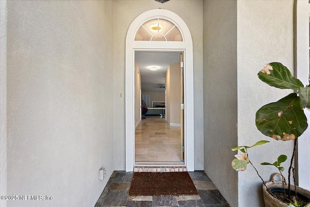 view of exterior entry with stucco siding