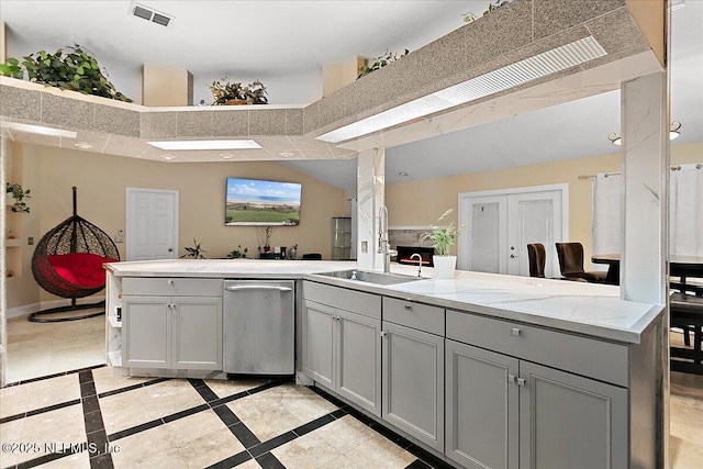 kitchen with gray cabinets, baseboards, visible vents, and a sink