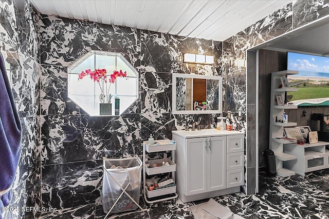 bathroom with wood ceiling, marble finish floor, and vanity