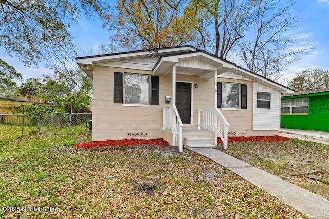 bungalow-style house with crawl space and fence