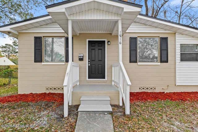 entrance to property featuring fence