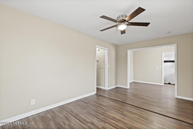 spare room with ceiling fan, baseboards, and wood finished floors