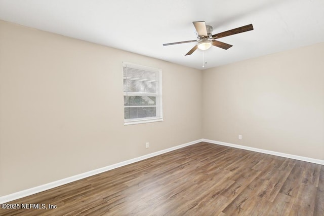 spare room featuring ceiling fan, wood finished floors, and baseboards