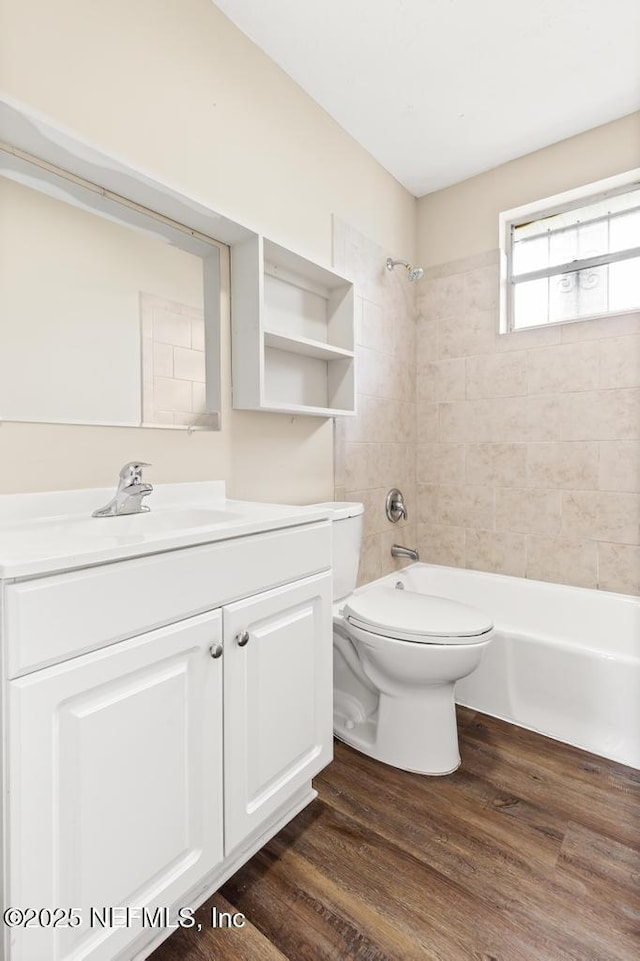 full bathroom with vanity, bathtub / shower combination, wood finished floors, and toilet