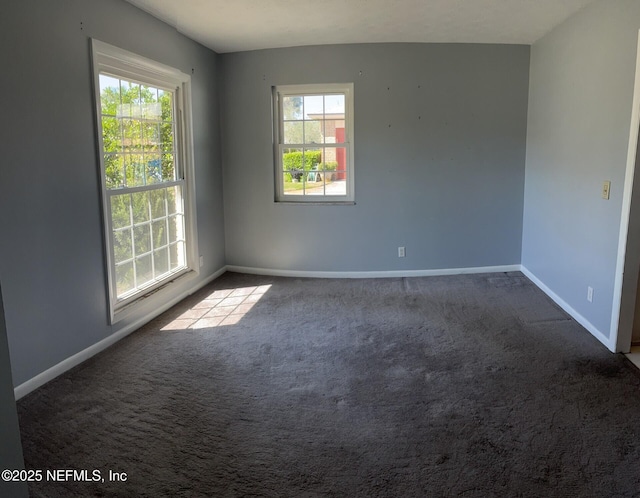 unfurnished room with carpet and baseboards