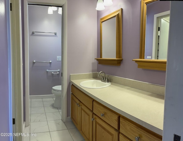 bathroom with toilet, marble finish floor, baseboards, and vanity